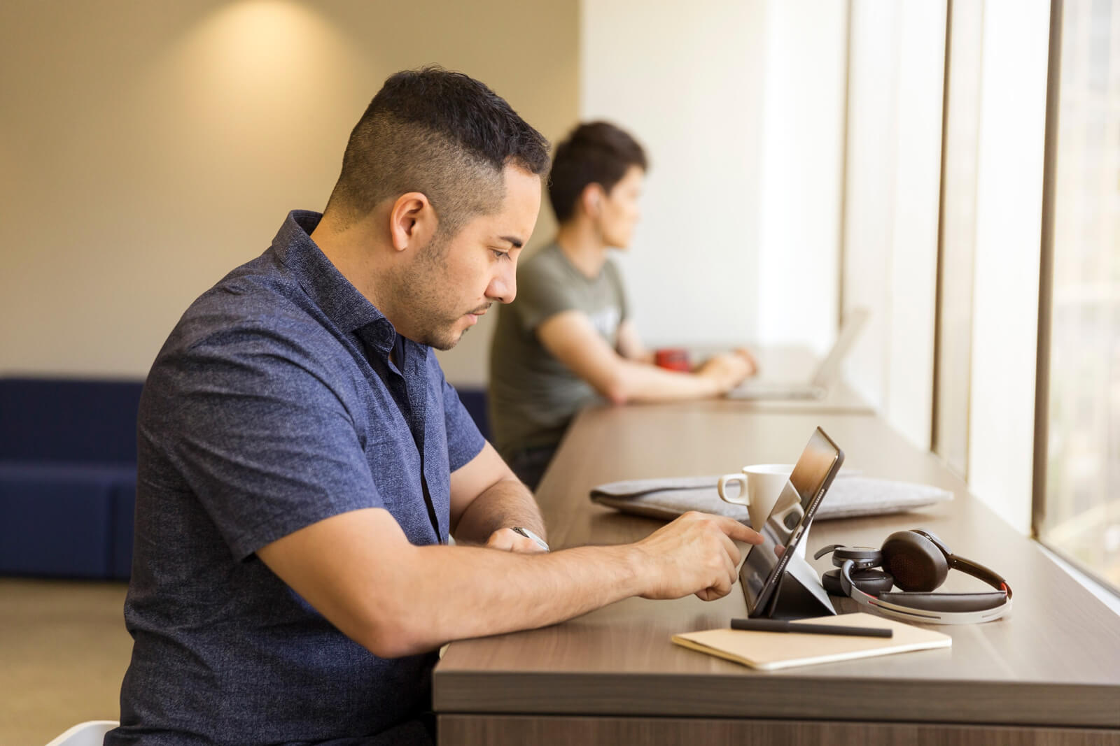 Man at ipad sending resume or applying for jobs